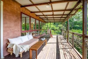 a porch with a couch on a wooden deck at Family-Friendly Hinterland Stay l Nova Escapes in Dorroughby
