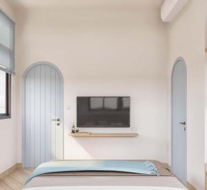 a bedroom with a bed and a tv on the wall at 68 Hotel Go Cong in Gò Công
