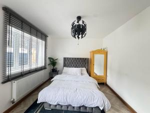 a bedroom with a bed and a large window at Erith cosy retreat in Erith