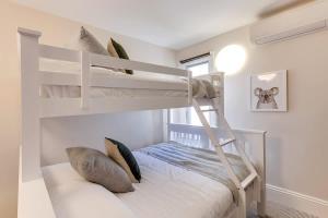 a bedroom with two bunk beds and a window at 2 mins walking to harbour bridge in Sydney