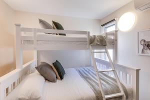a bedroom with two bunk beds and a ladder at 2 mins walking to harbour bridge in Sydney +31 photos