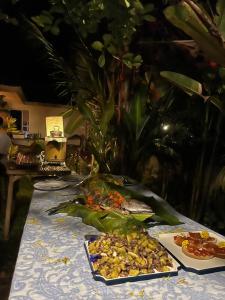 a table with plates of food on top at Calamansi Garden - Full House Rental in Burgos +15 photos