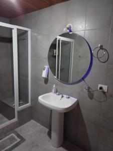 a bathroom with a sink and a mirror at Casa Nómade in Perito Moreno