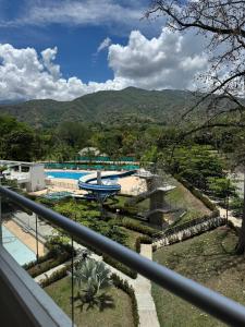 a view of a pool from a balcony of a resort at Citadela Disole Paraíso in Santa Fe de Antioquia