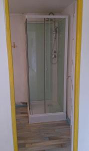 a shower with a glass door in a bathroom at Tavaud in Dournazac