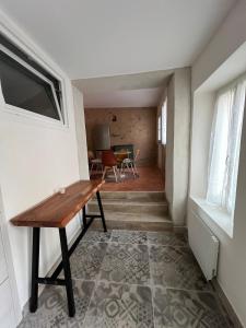 a hallway with a wooden table in a room at La bâtisse de Coustouge in Coustouge
