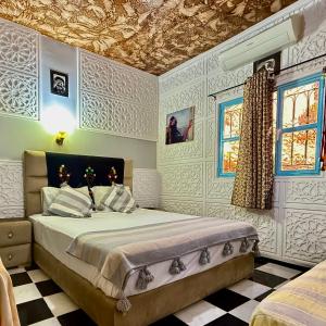Кровать или кровати в номере La Maison Traditionnelle Hôtel et guesthouse