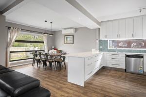 a kitchen and dining room with a table and chairs at Balnarring Beach Haven - peaceful retreat, walk to beach in Balnarring Beach
