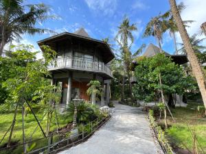 a house with a walkway in front of it at Mega Resort Karimunjawa in Karimunjawa