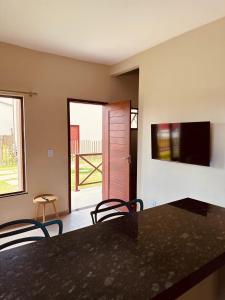 a kitchen with a table and chairs and a window at Sorte e Amaro in Santo Amaro