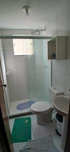 a bathroom with a shower and a toilet and a sink at AP térreo-Rio das Ostras próx Enseada -Costazul in Rio das Ostras +30 photos