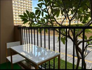 a white table on a balcony with a tree at Be Housed Studio Bldg 302 in Lapu Lapu City