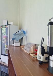 a counter in a kitchen with a mixer and a counter top at Tangkoko Hideaway Cottage in Pulau Mogogimbun