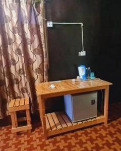a wooden table with a sink and a mirror at Rainbow Tioman Cottage in Kampong Juara