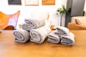 a pile of towels sitting on top of a table at 真 Private accommodation with sauna, close to USJ and Expo Park, free parking, 4 bedrooms, 8 beds, 2 bathrooms in Osaka +91 photos