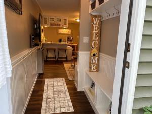 a hallway of a home with a kitchen and a dining room at The Hive - Unique Themed Getaway in Billerica