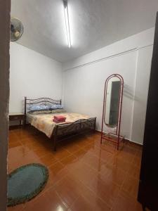 Ένα ή περισσότερα κρεβάτια σε δωμάτιο στο PD Perdana Homestay 3BR