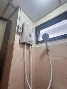 a blow dryer in a bathroom with a window at Budget room Suvarnabhumi Airport ห้องราคาประหยัด สนามบินสุวรรณภูมิ in Ban Khlong Prawet