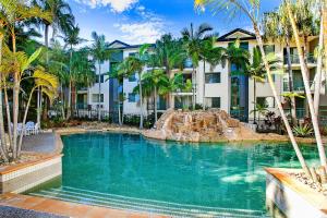 a swimming pool with a water park in front of a building at Beautiful Palm Beach in Gold Coast