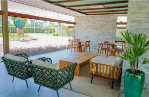 a patio with a table and chairs and tables at Loft Mana Experience INN in Ipojuca