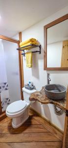 a bathroom with a toilet and a mirror at Mariposa - Cabañas Puerto del Zopilote in Pinal de Amoles