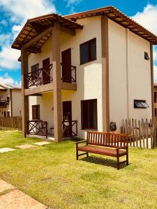 a wooden bench in front of a house at Sorte e Amaro in Santo Amaro