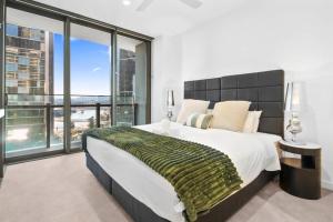 a bedroom with a large bed and a large window at Queens Wharf - Brisbane CBD Luxury with pool and gym in Brisbane