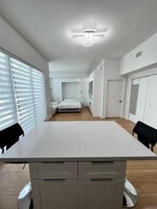 a kitchen with a large white counter top in a room at Fully Equipped Modern Loft in the heart of Miami in Miami