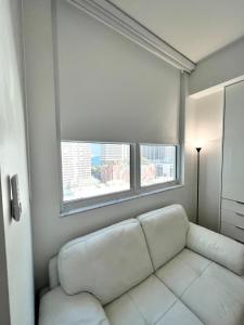 a white couch in a room with a window at Fully Equipped Modern Loft in the heart of Miami in Miami +56 photos