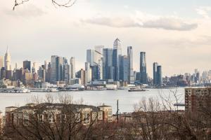a view of a city skyline with a harbor at Prime Location Explore NYC in West New York