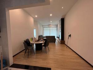 a living room with a table and chairs and a couch at Alan Garden Apartment in Sibu