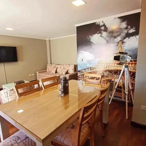 a dining room with a table and a painting on the wall at Departamento Caseros Centro in Salta