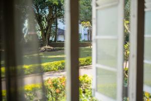 a view through an open window of a yard at Fortuna Bungalows in Kandy