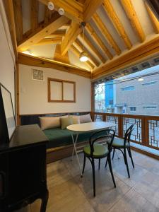 a living room with a couch and a table and chairs at Stay 148 in Seoul