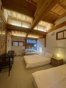 a large room with two beds and a table at Stay 148 in Seoul