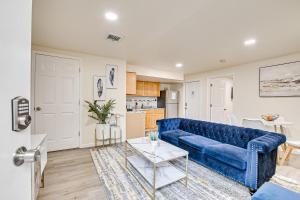 a living room with a blue couch and a kitchen at Quite and Spacious Apartment in Elizabeth