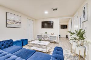 a living room with blue couches and a tv at Quite and Spacious Apartment in Elizabeth