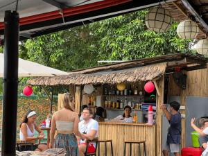 a group of people sitting at a bar at Reef Haven in Puerto Galera