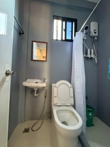 a small bathroom with a toilet and a sink at Reef Haven in Puerto Galera +12 photos