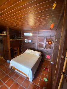 a bedroom with a white bed in a room at Sítio Borsoilândia in Benevides +12 photos