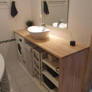 a bathroom with a sink and a washing machine at Wielkopolska 22 in Szczecin