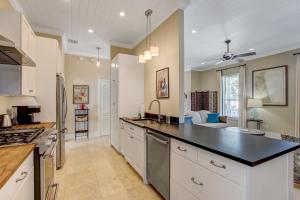 a kitchen with white cabinets and a black counter top at 1016 San Fernando Street home in Fernandina Beach +31 photos