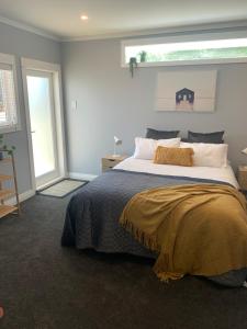 a bedroom with a large bed with a window at Central, secure and upmarket Auckland in Auckland