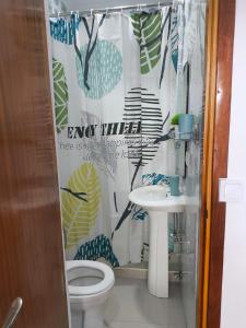 a bathroom with a toilet and a sink at Old Town view Apartment in Cidade Velha