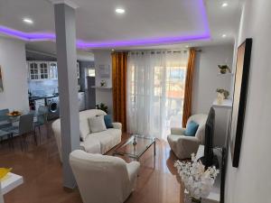 a living room with white furniture and a purple ceiling at Old Town view Apartment in Cidade Velha