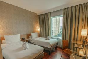 En eller flere senger på et rom på Hotel KIMAYA Slipi Jakarta By HARRIS