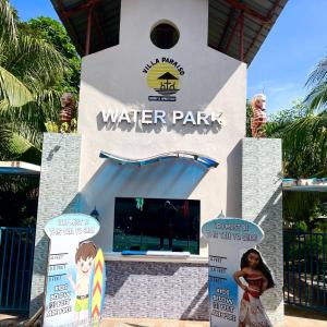 a water park with a little girl standing in front of it at Villa Paraiso Resort & Waterpark in Bokbok +2 photos