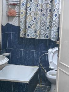 a bathroom with a toilet and a shower curtain at travel adventures 