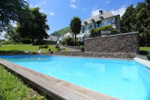 a swimming pool with a house in the background at Le Belvedere in Salles