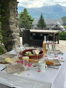 a table with a plate of food and wine glasses at Le Belvedere in Salles